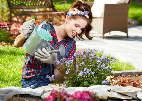 Gardener pruning shrubs in Palmers Green garden
